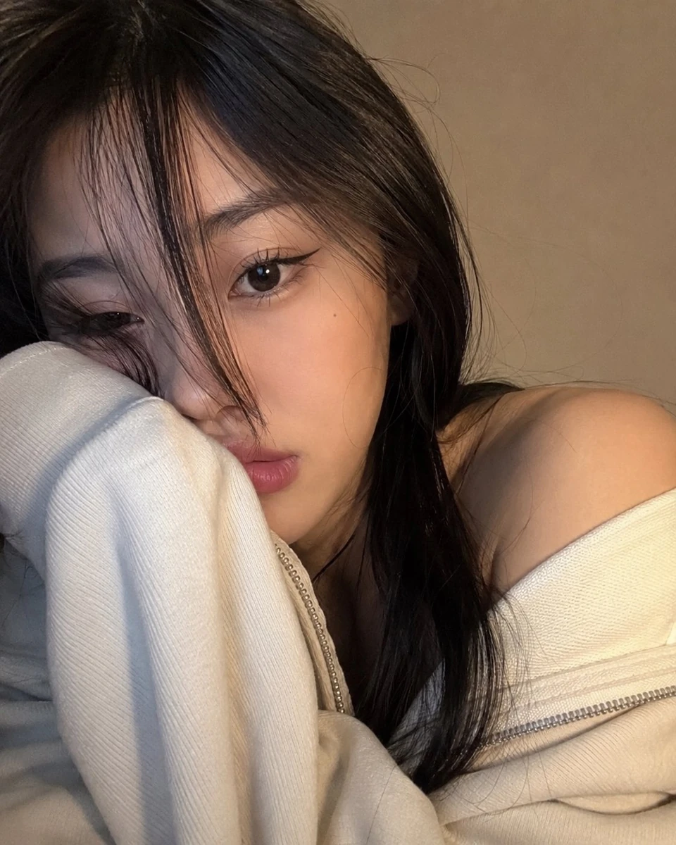 A photorealistic, ultra-close selfie-style portrait of a young woman occu...
