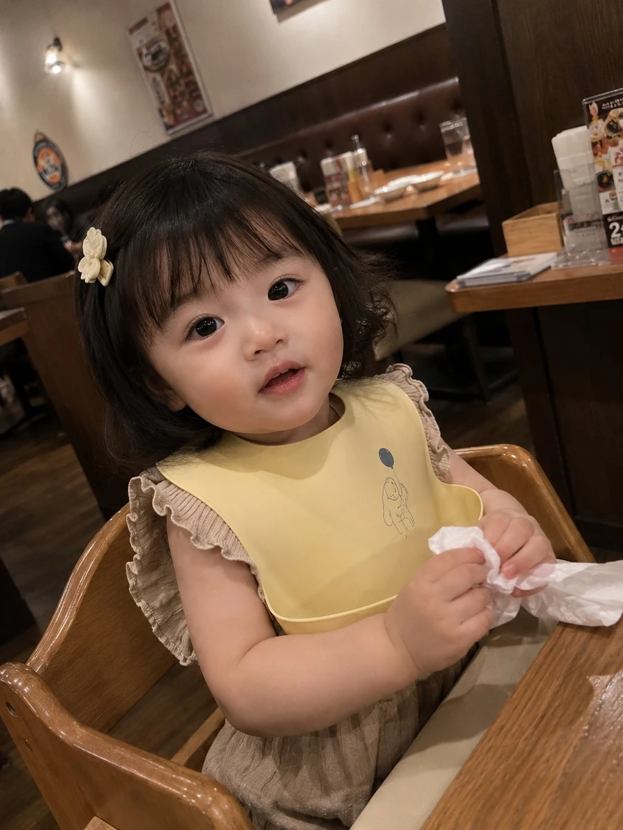 Photorealistic candid smartphone snapshot of an adorable toddler girl sit...