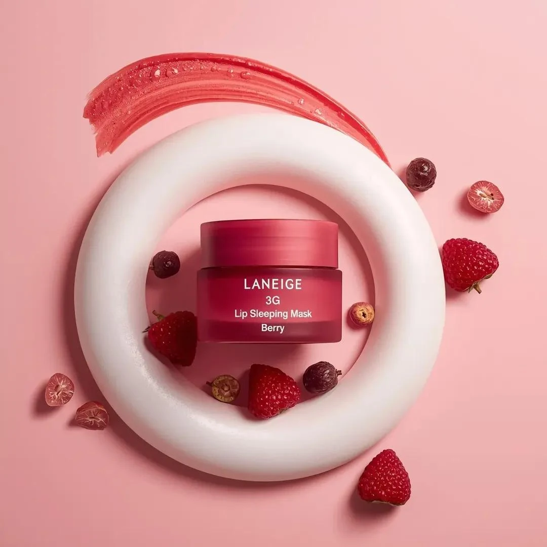 A centrally placed pink cosmetic jar labeled “LANEIGE Lip Sleeping Mask [...