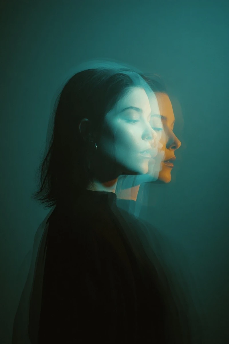 Cinematic double exposure portrait of a woman in side profile, two overla...