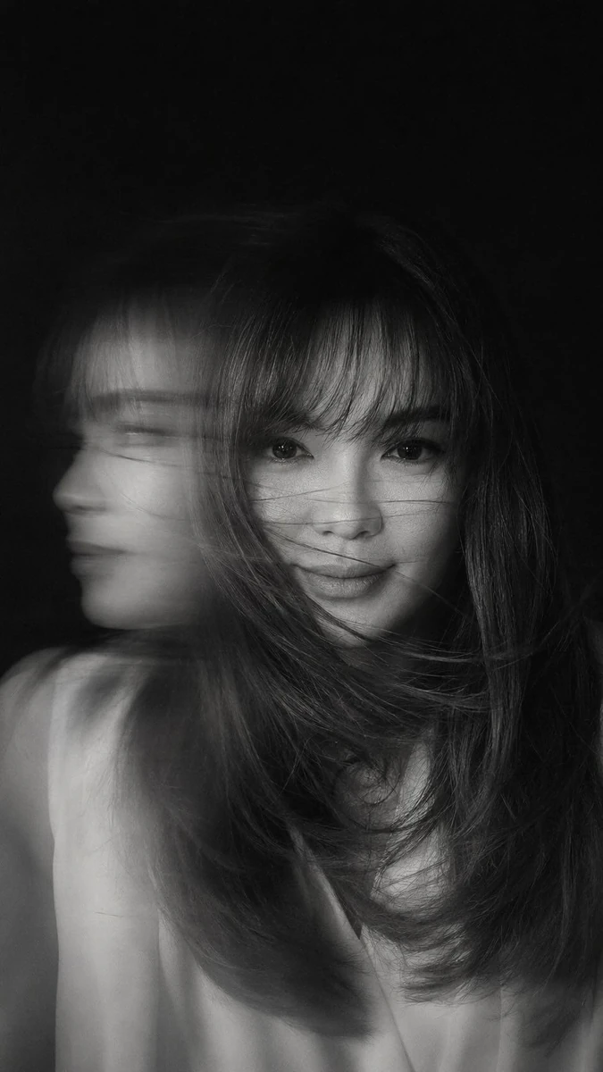 A hyper-realistic, cinematic black-and-white portrait of a woman caught i...