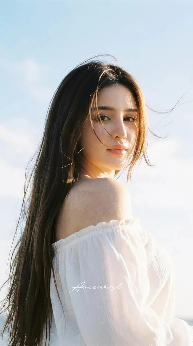 HAIRSTYLE: Ultra‑long, sleek dark brown hair with warm sun‑kissed highlig...