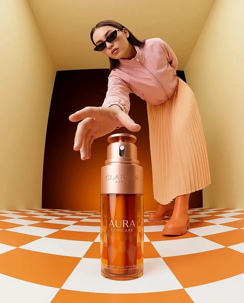 “Surreal fashion product photography of a giant amber skincare bottle (Cl...