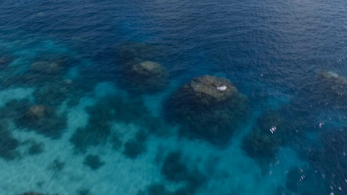 A hyper-realistic, high-cinematic aerial drone shot of a vintage yellow s...