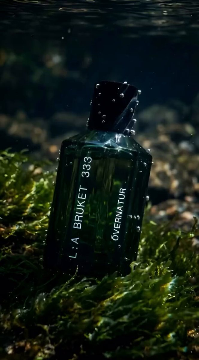 Luxury green glass perfume bottle with wooden cap labeled “LA BRUKET 333”...