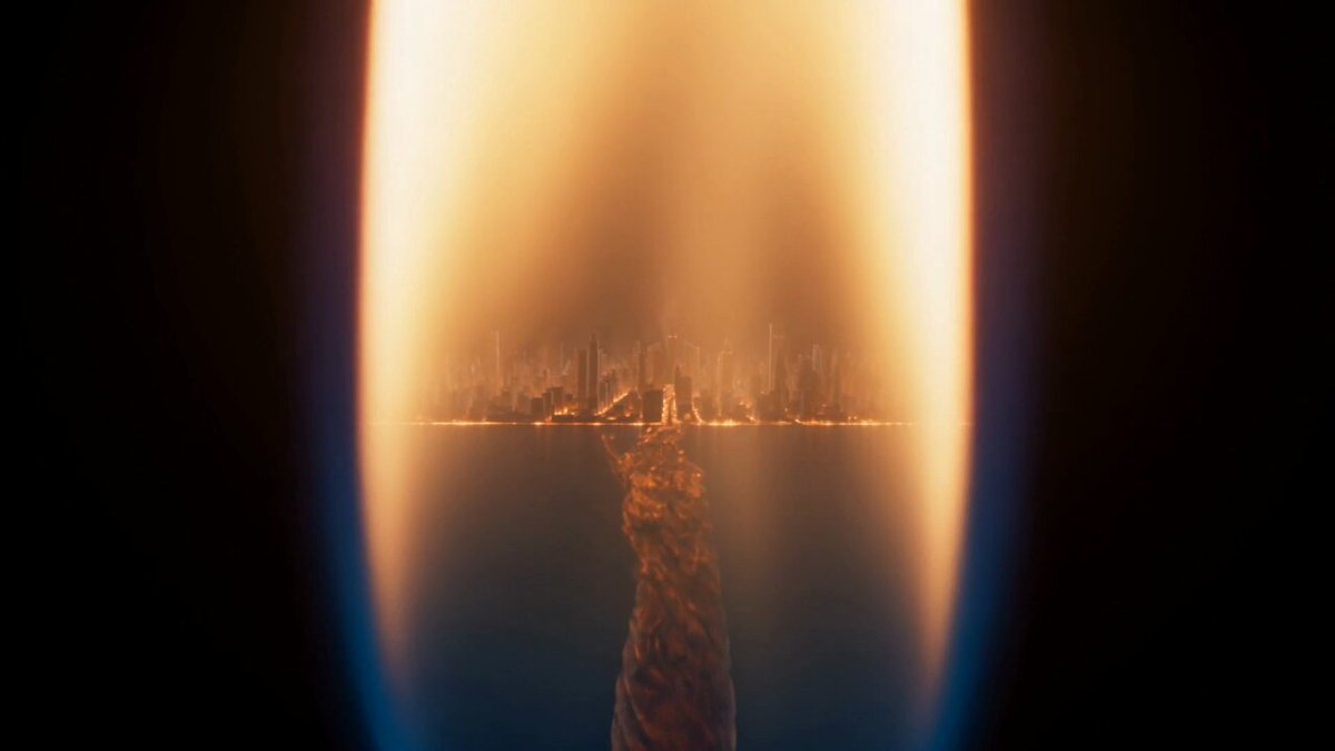 Extreme macro shot of a single candle flame burning in a dark room. The b...