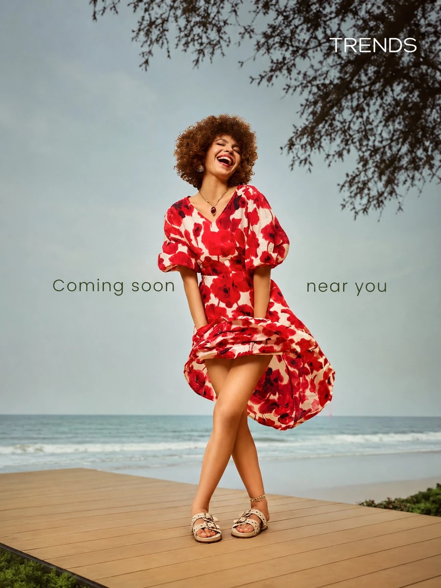 A joyful young woman with beautiful voluminous curly afro brown hair, lau...