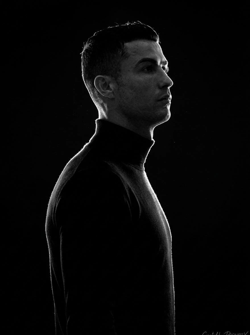 A stark, high-contrast, black-and-white (monochromatic) side-profile port...