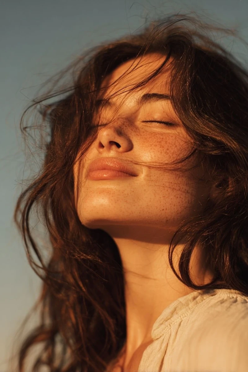 Ultra-realistic golden hour close-up portrait of a young woman outdoors,...