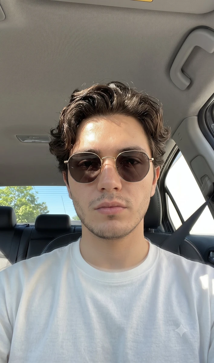 A candid smartphone front-camera selfie of a man with a Mediterranean or...