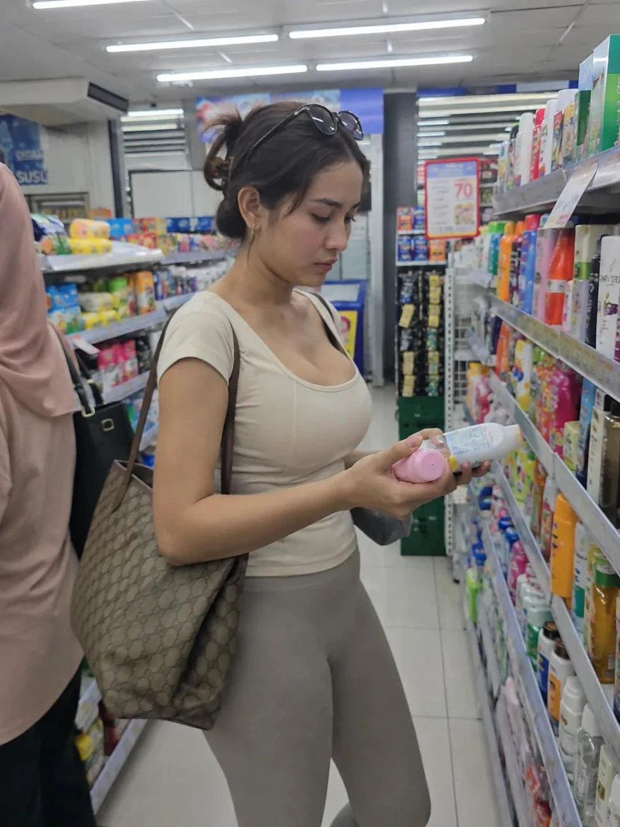 Photorealistic candid lifestyle photo of a young woman shopping in a brig...