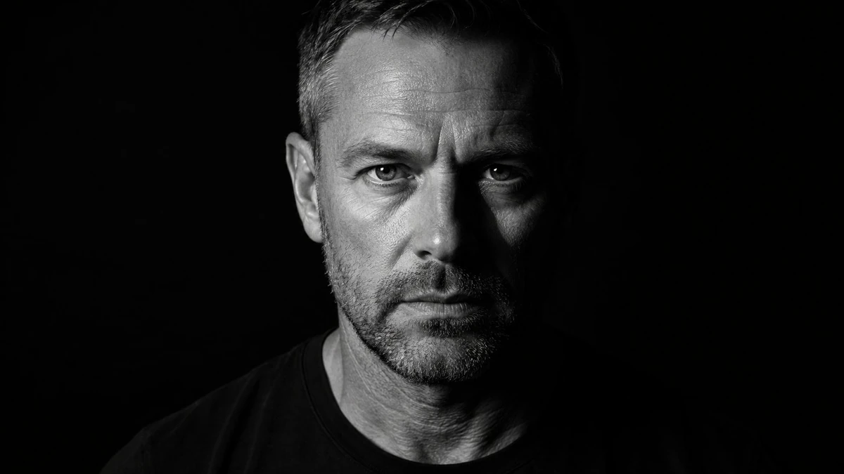 Photorealistic black and white cinematic portrait of a rugged middle aged...