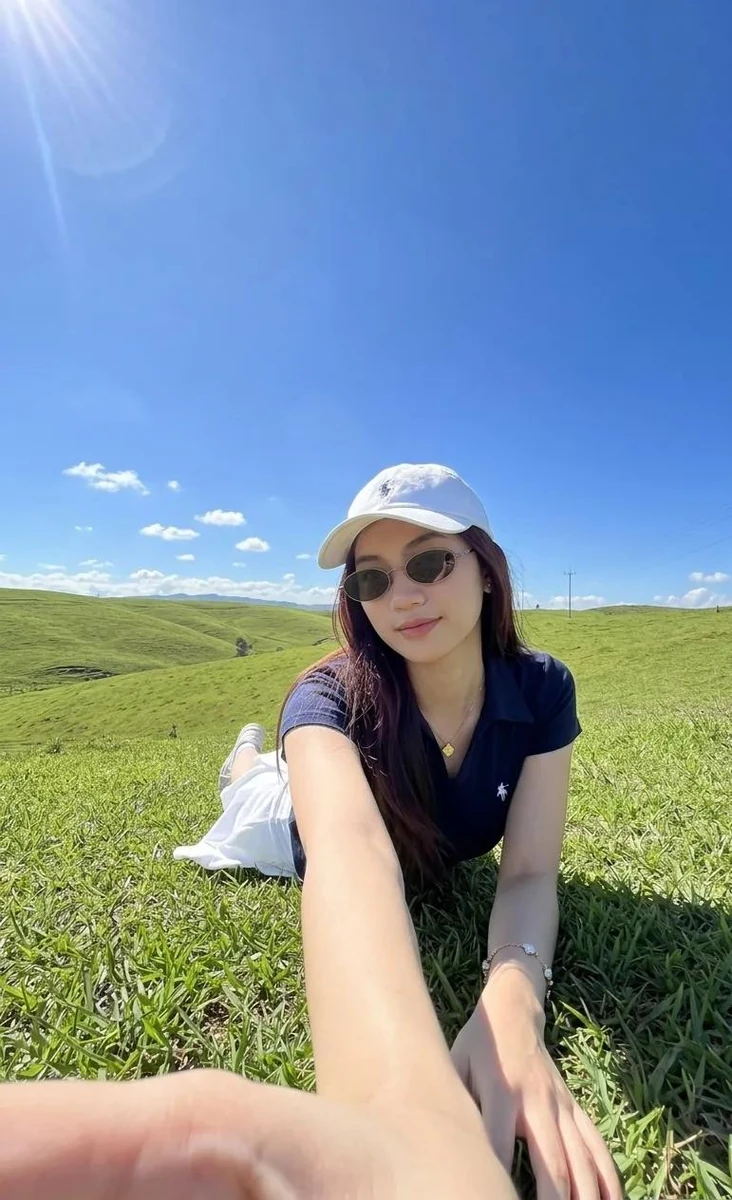 This very natural-looking smartphone photo depicts a young woman lying on...