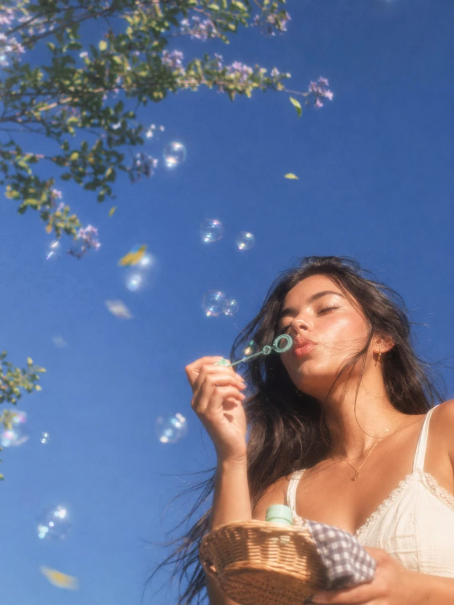 A dreamy, ultra-photorealistic springtime lifestyle portrait captured fro...