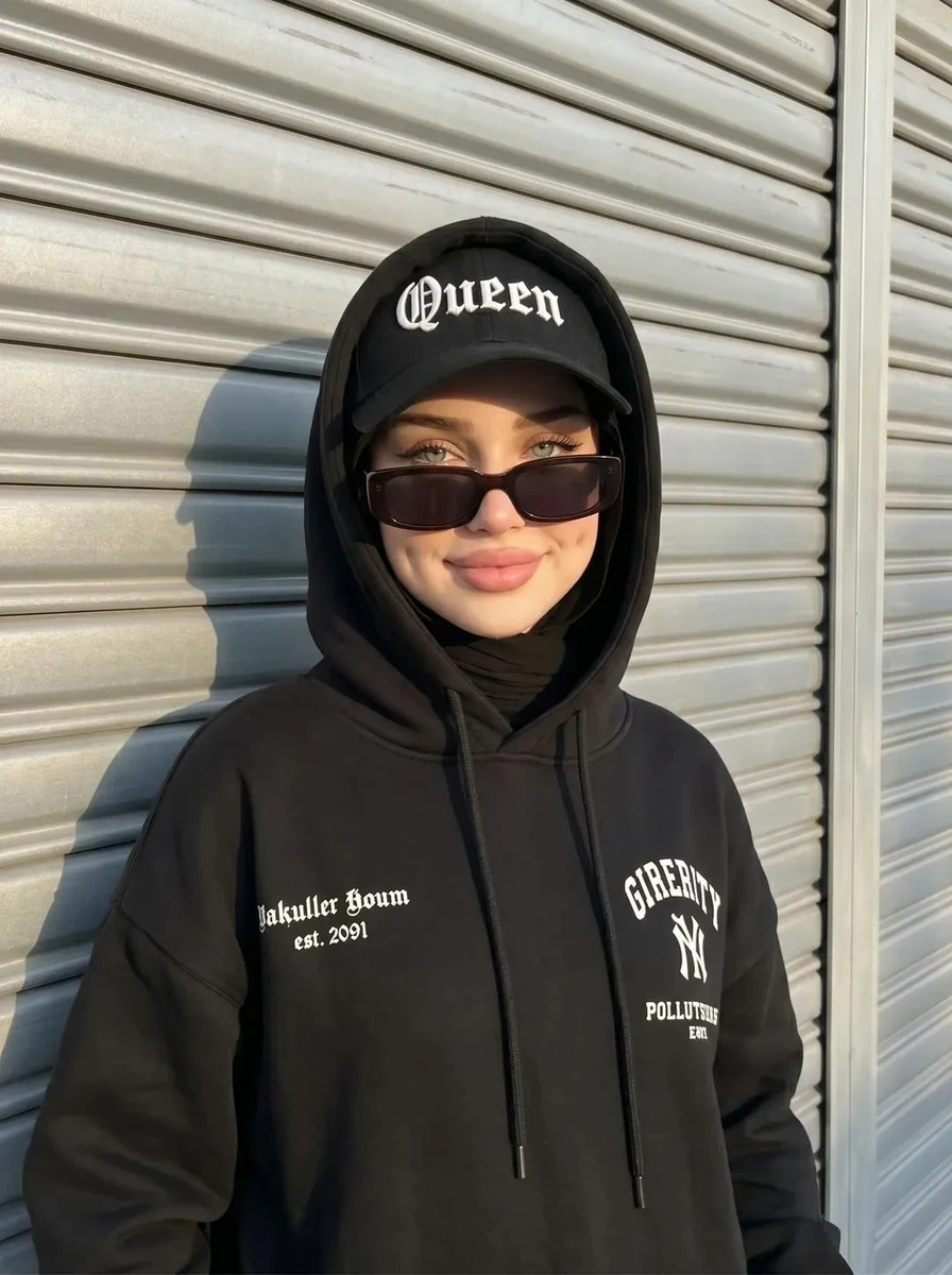 A street-style portrait of a hijabi woman with a cool and edgy aura. She...