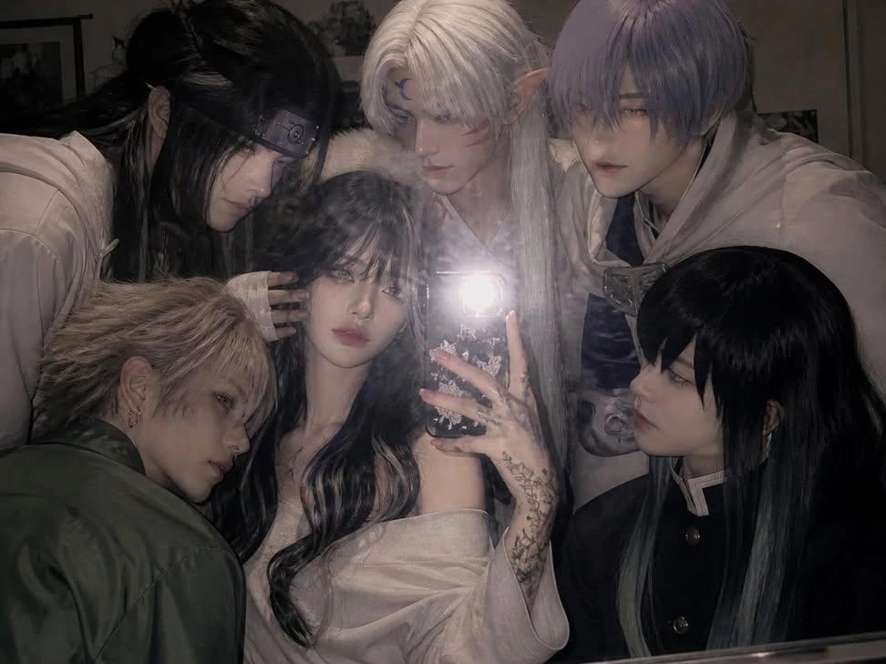 Holding a phone with the flash on, taking a mirror selfie in a slightly m...