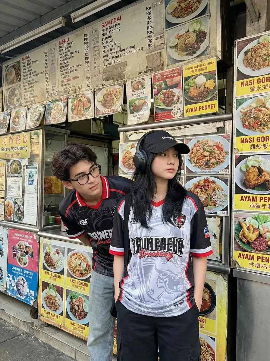 A candid street photography shot of two young Asian adults standing in fr...