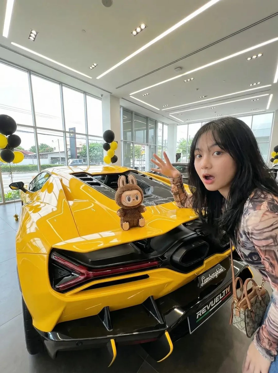 A modern luxury car showroom with floor-to-ceiling glass windows and brig...